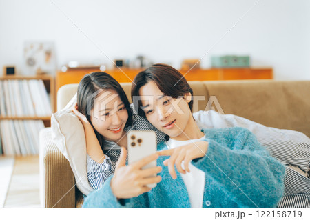 一緒にスマホを見る若いカップル 一緒にスマホを見る若いカップル 122158719