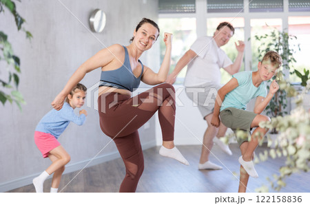 Parents with young daughter and schoolboy son are taught to move to boogie-woogie Parents with young daughter and schoolboy son are taught to move to boogie-woogie 122158836
