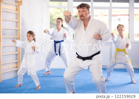 Family with children training karate techniques 122159029