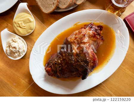Fried pork knuckle (boar knee) with mustard and horseradish. Traditional czech dish Fried pork knuckle (boar knee) with mustard and horseradish. Traditional czech dish 122159220