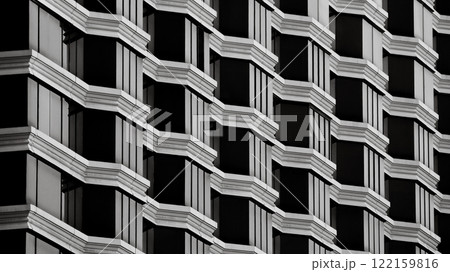 a repetitive architectural facade with geometric patterns of black and white, creating a striking and symmetrical composition. 122159816