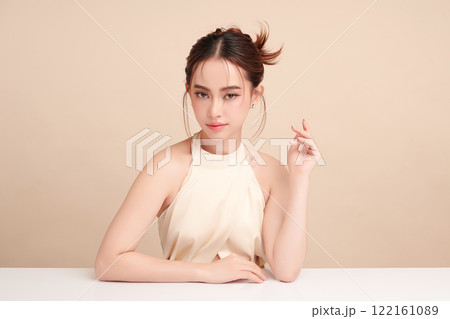 Beautiful young asian woman with clean fresh skin on beige background, Face care, Facial treatment, Cosmetology, beauty and spa, Asian women portrait. Beautiful young asian woman with clean fresh skin on beige background, Face care, Facial treatment, Cosmetology, beauty and spa, Asian women portrait. 122161089