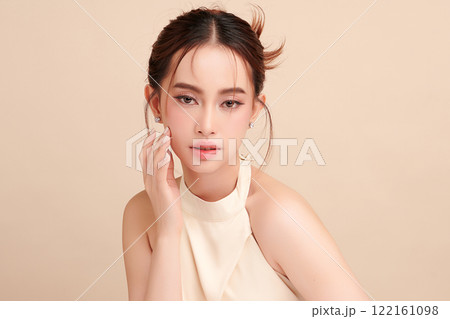 Beautiful young asian woman with clean fresh skin on beige background, Face care, Facial treatment, Cosmetology, beauty and spa, Asian women portrait. 122161098