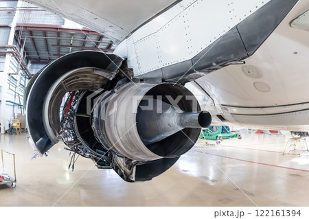 Rear view of the open high-bypass turbofan aircraft engine of a passenger jet plane in a hangar Rear view of the open high-bypass turbofan aircraft engine of a passenger jet plane in a hangar 122161394