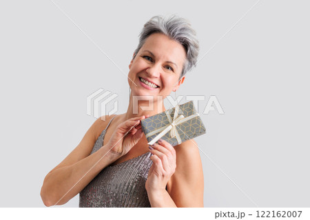 Beautiful happy middle-aged elderly woman with gray short hair smiling and looking at camera 122162007