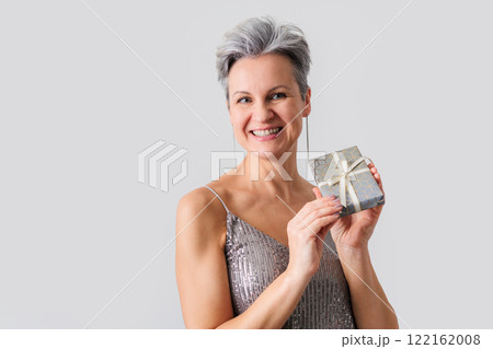 Smiling happy lady 50 years old with gray hair and short haircut looking at camera 122162008