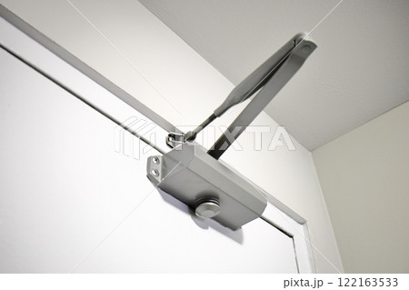 Automatic hydraulic door closer close up view Automatic hydraulic door closer close up view 122163533