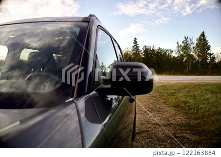 black car on the side of the road outside the city 122163884