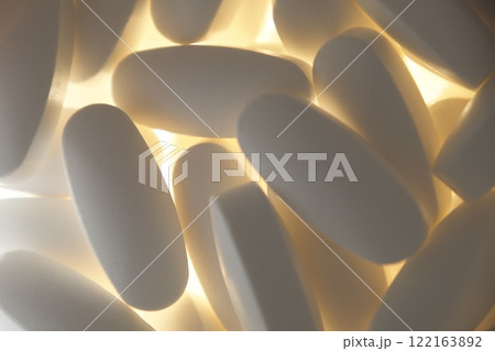 white pills on a light background close up white pills on a light background close up 122163892