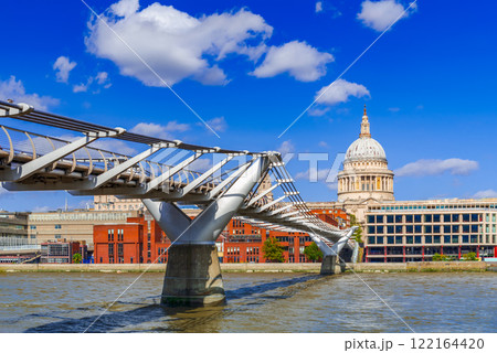London, United Kingdom. Millennium Bridge over Thames River and Saint Paul Anglican cathedral dome 122164420