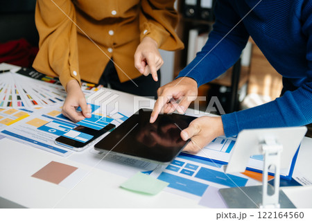 Close up view of UI developer team brainstorming on their project with laptop, smartphone and digital tablet. Creative digital development agency. 122164560