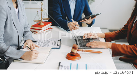 business people and lawyers discussing contract papers sitting at the table. Concepts of law, advice, legal services. 122164571