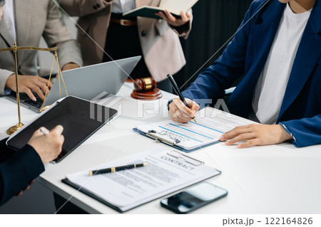business people and lawyers discussing contract papers sitting at the table. Concepts of law 122164826