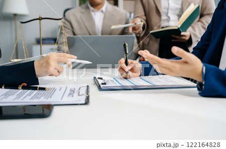 business people and lawyers discussing contract papers sitting at the table. Concepts of law business people and lawyers discussing contract papers sitting at the table. Concepts of law 122164828