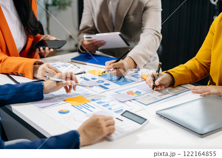 Businessman and team analyzing financial statement Finance task. with smart phone and laptop and tablet. Businessman and team analyzing financial statement Finance task. with smart phone and laptop and tablet. 122164855
