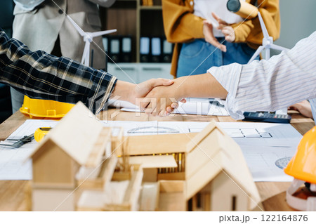 Engineer desk with object paper and tablet with blurry engineer teamwork hardworking Engineer desk with object paper and tablet with blurry engineer teamwork hardworking 122164876