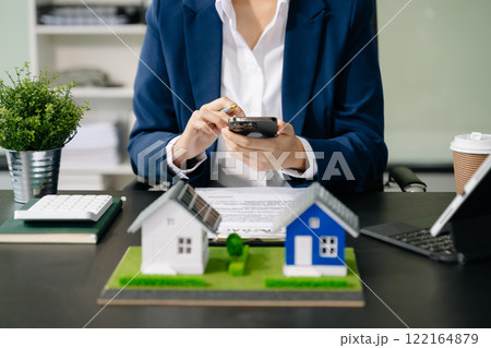 Real estate broker agent presenting and consult to customer to decision making sign insurance form agreement, home model, 122164879