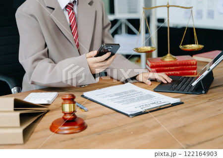 Justice and law concept.Male judge in a courtroom on white table and Counselor or Male lawyer working 122164903