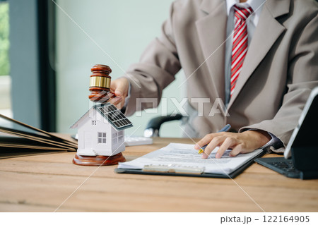 Real Estate Lawyer And House Foreclosure Law. House model, hammer judge gavel on table with white background. Foreclosure, bankruptcy concept 122164905