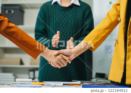 Two confident business man shaking hands during a meeting in the office, success, dealing, greeting and partner Two confident business man shaking hands during a meeting in the office, success, dealing, greeting and partner 122164912