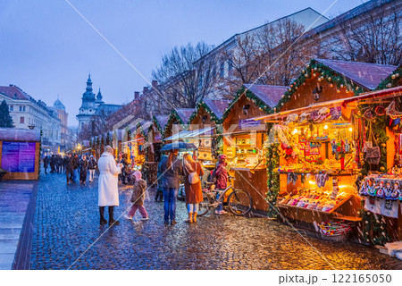 Cluj Christmas Market, illuminated stalls, holiday decorations, twinkling lights, cozy atmosphere, vibrant winter celebration in Transylvania, Romania. 122165050