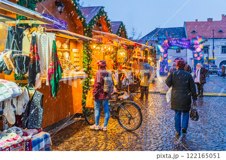 Cluj Christmas Market, illuminated stalls, holiday decorations, twinkling lights, cozy atmosphere, vibrant winter celebration in Transylvania, Romania. 122165051