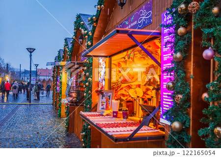 Cluj Christmas Market, illuminated stalls, holiday decorations, twinkling lights, cozy atmosphere, vibrant winter celebration in Transylvania, Romania. Cluj Christmas Market, illuminated stalls, holiday decorations, twinkling lights, cozy atmosphere, vibrant winter celebration in Transylvania, Romania. 122165054
