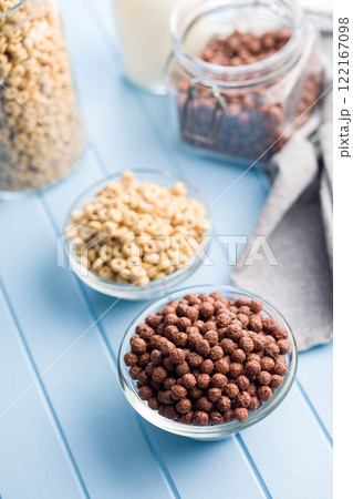 Breakfast cereal chocolate balls in bowl on blue table. Breakfast cereal chocolate balls in bowl on blue table. 122167098