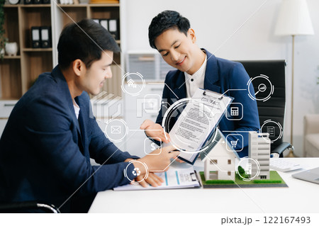 Real estate broker agent presenting and consult to customer to decision making sign insurance form agreement, home model, concerning mortgage loan offer Real estate broker agent presenting and consult to customer to decision making sign insurance form agreement, home model, concerning mortgage loan offer 122167493