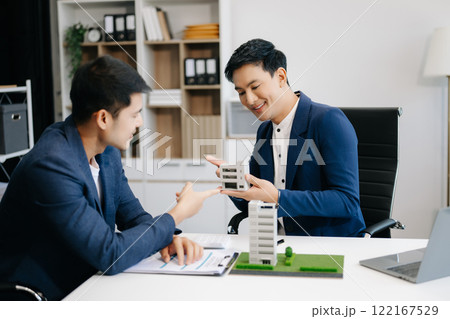 balancing the property sector The real estate agent is explaining the house style to see the house design and the purchase agreement. model house 122167529