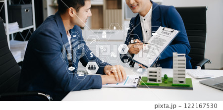 Real estate broker agent presenting and consult to customer to decision making sign insurance form agreement, home model, concerning mortgage loan offer 122167530