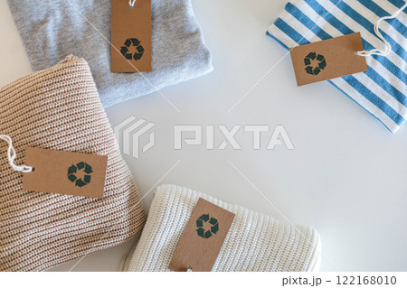 Folded cotton knitted clothes recycling made reusing material craft tag top view isolated on white 122168010