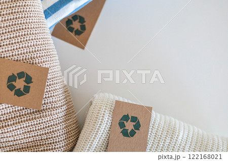 Folded cotton knitted clothes recycling made reusing material craft tag top view isolated on white 122168021