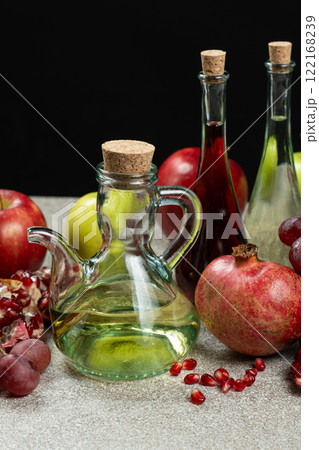 Vinegar in a glass vinegar bowl with a spout on a black background. 122168239