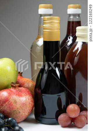 Different types of vinegar. Balsamic, pomegranate and apple vinegars in bottles Different types of vinegar. Balsamic, pomegranate and apple vinegars in bottles 122168249
