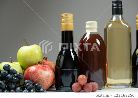 Different types of vinegar, Balsamic, pomegranate and apple vinegars in bottles Different types of vinegar, Balsamic, pomegranate and apple vinegars in bottles 122168250