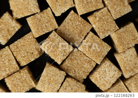 Cubes of brown cane unrefined demerara sugar. 122168263