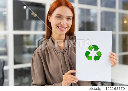 Smiling young woman presenting a waste recycling project 122168370