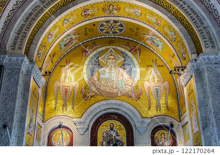 people pray in an Orthodox church, frescoes on the ceilings and walls of the church 122170264