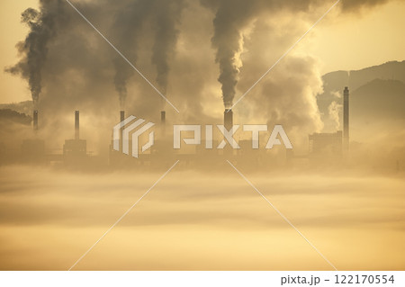 A haunting view of industrial chimneys spewing black smoke, 122170554