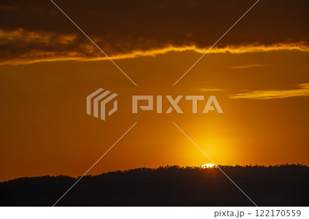 Fiery Sunset over Silhouette Landscape Fiery Sunset over Silhouette Landscape 122170559