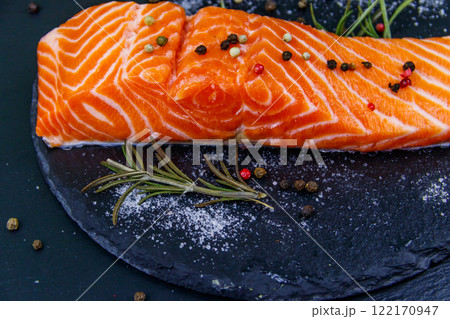 Raw salmon fillet with spices on black slate Raw salmon fillet with spices on black slate 122170947