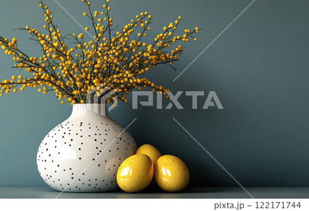 Easter decoration golden eggs yellow mimosa in white vase blue wall background, copy space for text 122171744