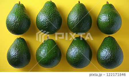 Whole avocados yellow background, top view avocado leaves, space for text, vegetarian food, vitamin 122171846