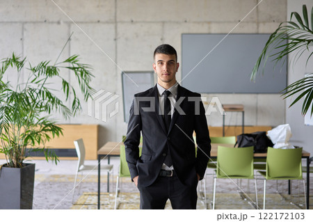 A close up portrait of a company director in a black suit, standing confidently in a modern office, exuding leadership, professionalism, and authority. A close up portrait of a company director in a black suit, standing confidently in a modern office, exuding leadership, professionalism, and authority. 122172103