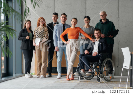 Multiethnic Business Team Collaborating in a Modern Office with Director in a Wheelchair 122172111