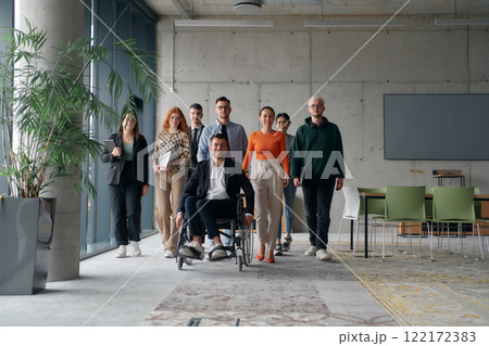 A diverse group of business professionals walking together through the office, symbolizing unity and strength as a collaborative and successful team 122172383