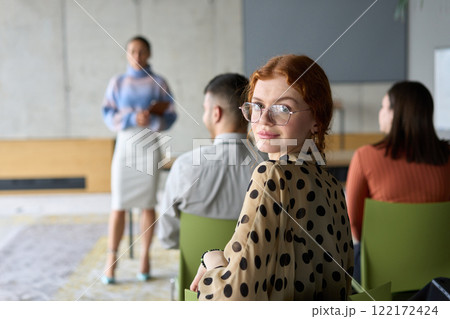 A diverse group of business professionals sits attentively in a modern office, actively participating in a training session led by an instructor, focusing on the latest technological advancements in A diverse group of business professionals sits attentively in a modern office, actively participating in a training session led by an instructor, focusing on the latest technological advancements in 122172424