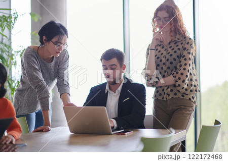A diverse multiethnic business team engages in a collaborative meeting, discussing strategies and solutions in a modern office setting 122172468
