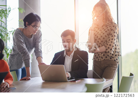 A diverse multiethnic business team engages in a collaborative meeting, discussing strategies and solutions in a modern office setting 122172563
